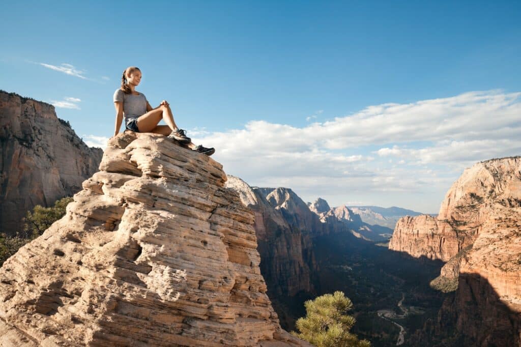 Young woman on the top of Angel’s landing mountain, Utah